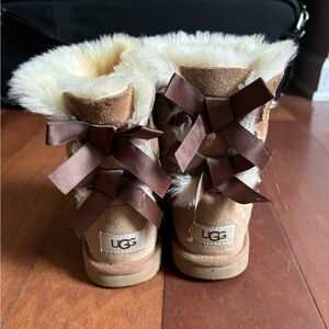 Girls camel colored Ugg boots with bows